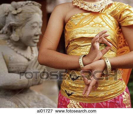 Indonesia, Bali, Balinese dancer close up, statue in background View Large Photo Image Stock Photo - Indonesia, Bali, Balinese dancer close up, statue in background. Fotosearch
