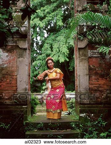 Indonesia, Bali, Balinese dancer in doorway, trees in background View Large Photo Image Stock Image - Indonesia, Bali, Balinese dancer in doorway, trees in background. Fotosearch