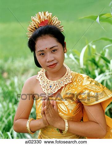 Indonesia, Bali, Balinese dancer in traditional costume, portrait in field View Large Photo Image Stock Image - Indonesia, Bali, Balinese dancer in traditional costume, portrait in field. Fotosearch
