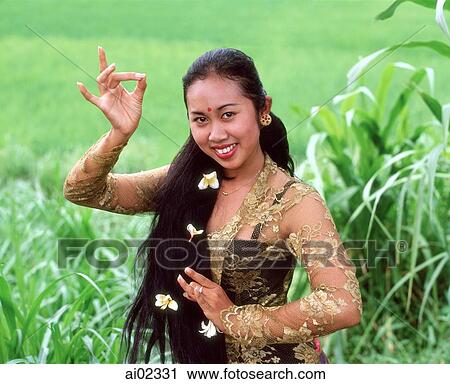 Indonesia, Bali, Balinese dancer in traditional costume, portrait in field View Large Photo Image Stock Image - Indonesia, Bali, Balinese dancer in traditional costume, portrait in field. Fotosearch