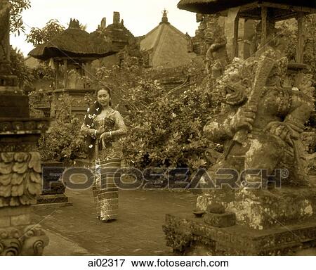 Stock Photo - Indonesia, Bali, Balinese dancer in traditional costume, in garden. Fotosearch