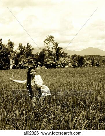 Indonesia, Bali, Balinese dancer in fields, trees in background View Large Photo Image Stock Photograph - Indonesia, Bali, Balinese dancer in fields, trees in background. Fotosearch