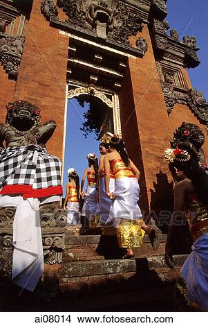 Indonesia, Bali, Gianyar, Cremation ceremony, girls from ceremonial procession enter temple. (grainy) View Large Photo Image Picture - Indonesia, Bali, Gianyar, Cremation ceremony, girls from ceremonial procession enter temple. (grainy). Fotosearch