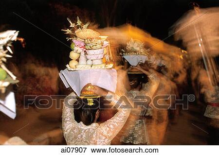 Indonesia, Bali, Gianyar, Cremation ceremony, women carry offerings to funeral grounds after cremation. (grainy) View Large Photo Image Stock Photo - Indonesia, Bali, Gianyar, Cremation ceremony, women carry offerings to funeral grounds after cremation. (grainy). Fotosearch