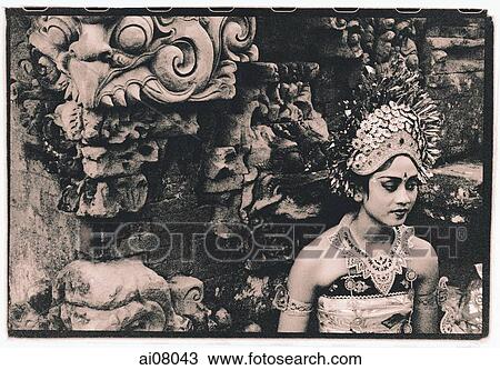 Indonesia, Bali, Gianyar, Oleg dancer waits to perform, sitting next to temple guardian. ( artistic grain) View Large Photo Image Stock Image - Indonesia, Bali, Gianyar, Oleg dancer waits to perform, sitting next to temple guardian. ( artistic grain). Fotosearch