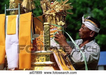 Indonesia, Bali, Gianyar, Pengastian ceremony, men decorating ceremonial tower. (grainy) View Large Photo Image Stock Photo - Indonesia, Bali, Gianyar, Pengastian ceremony, men decorating ceremonial tower. (grainy). Fotosearch