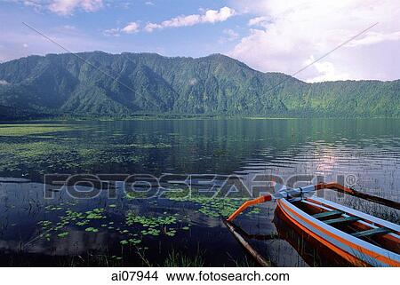 Indonesia, Bali, Lake Bratan, crater lake with fishing boat in foreground. (grainy) View Large Photo Image Picture - Indonesia, Bali, Lake Bratan, crater lake with fishing boat in foreground. (grainy). Fotosearch