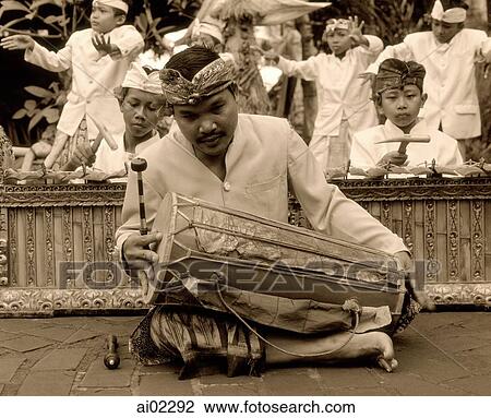 Indonesia, Bali, man playing hand drum, young boys in traditional costume dancing View Large Photo Image Stock Image - Indonesia, Bali, man playing hand drum, young boys in traditional costume dancing. Fotosearch