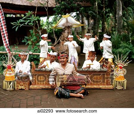 Indonesia, Bali, man playing hand drum, young boys in traditional costume dancing View Large Photo Image Stock Image - Indonesia, Bali, man playing hand drum, young boys in traditional costume dancing. Fotosearch