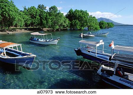 Stock Image - Indonesia, Bali, Menjangan, Dive boats moored in creek. (grainy). Fotosearch