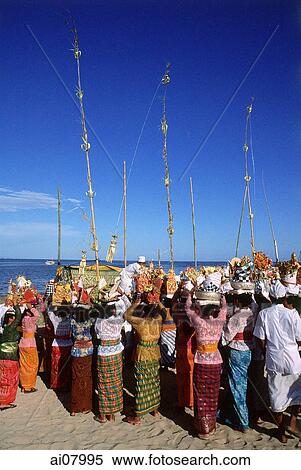 Indonesia, Bali, Tanjung Benoa, Women carrying offerings at Melasti ceremony on beach. (grainy) View Large Photo Image Stock Photography - Indonesia, Bali, Tanjung Benoa, Women carrying offerings at Melasti ceremony on beach. (grainy). Fotosearch