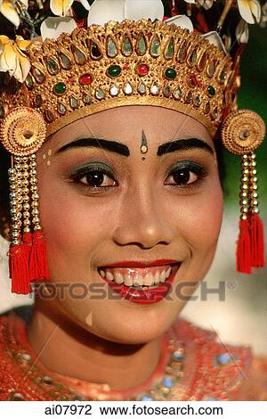 Indonesia, Bali, Ubud, Portrait of Legong dancer in headdress, smiling. (grainy) View Large Photo Image Stock Image - Indonesia, Bali, Ubud, Portrait of Legong dancer in headdress, smiling. (grainy). Fotosearch
