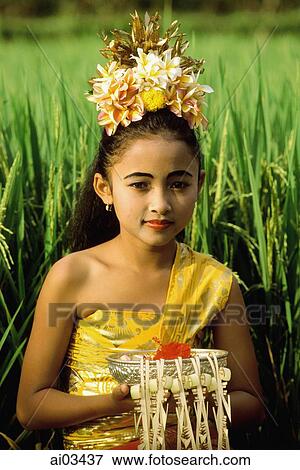 Indonesia, Bali, Young Balinese dancer in costume with offerings in rice paddy. View Large Photo Image Stock Photo - Indonesia, Bali, Young Balinese dancer in costume with offerings in rice paddy.. Fotosearch