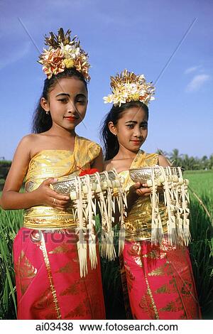 Indonesia, Bali, Young Balinese dancers in costume with offerings in