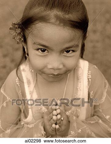 Indonesia, Bali, young girl, traditional greeting, portrait, elevated view View Large Photo Image Stock Photo - Indonesia, Bali, young girl, traditional greeting, portrait, elevated view. Fotosearch