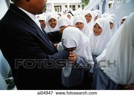 Indonesia, Jakarta, Muslim students kissing hand of Rector Noer Muhammad Iskandar, as a sign of respect. View Large Photo Image Stock Photo - Indonesia, Jakarta, Muslim students kissing hand of Rector Noer Muhammad Iskandar, as a sign of respect.. Fotosearch