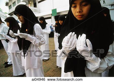 Indonesia, Jakarta, Muslim students offering prayers and ask for blessings on their country. View Large Photo Image Stock Photograph - Indonesia, Jakarta, Muslim students offering prayers and ask for blessings on their country.. Fotosearch