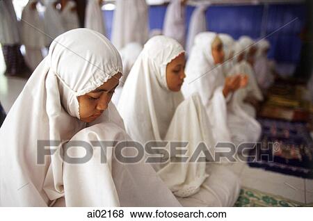 Indonesia, Jakarta, Students recite verses from the Koran at Asshiddiqiyah Islamic College. View Large Photo Image Stock Photo - Indonesia, Jakarta, Students recite verses from the Koran at Asshiddiqiyah Islamic College.. Fotosearch