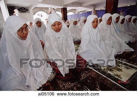 Indonesia, Jakarta, Young students at the Asshiddiqiyah Muslim School kneeling for prayers. View Large Photo Image Stock Photograph - Indonesia, Jakarta, Young students at the Asshiddiqiyah Muslim School kneeling for prayers.. Fotosearch