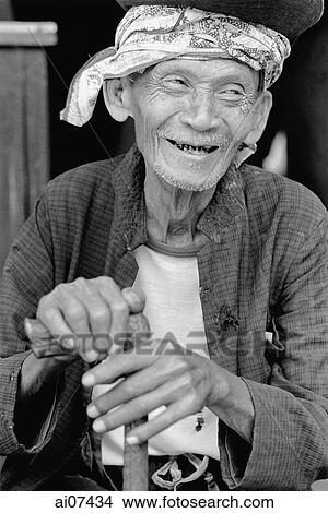Indonesia, Java, Blitar, Elderly man holding walking stick, smiling. View Large Photo Image Picture - Indonesia, Java, Blitar, Elderly man holding walking stick, smiling.. Fotosearch