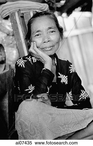 Indonesia, Java, Portrait of lady resting head on hand, smiling. View Large Photo Image Stock Photography - Indonesia, Java, Portrait of lady resting head on hand, smiling.. Fotosearch