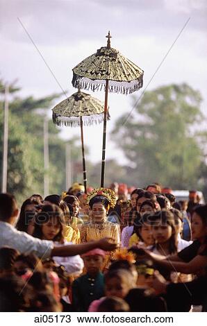 Indonesia, Lombok, a bride walking under a canopy and accompanied by female attendants, following musicians to the groom's home. View Large Photo Image Stock Image - Indonesia, Lombok, a bride walking under a canopy and accompanied by female attendants, following musicians to the groom's home.. Fotosearch