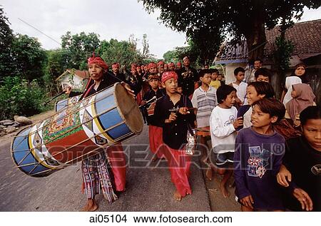 Indonesia, Lombok, Drummers leading a wedding procession past a crowd on the street. View Large Photo Image Picture - Indonesia, Lombok, Drummers leading a wedding procession past a crowd on the street.. Fotosearch