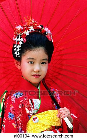 Picture - Japan, Shichi-Go-San Festival, seven year old girl with red umbrella. Fotosearch