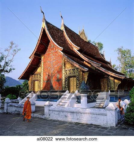 Laos, Luang Prabang, Novice monk walks in front of Wat Xieng Thong Temple. (grainy) View Large Photo Image Stock Image - Laos, Luang Prabang, Novice monk walks in front of Wat Xieng Thong Temple. (grainy). Fotosearch