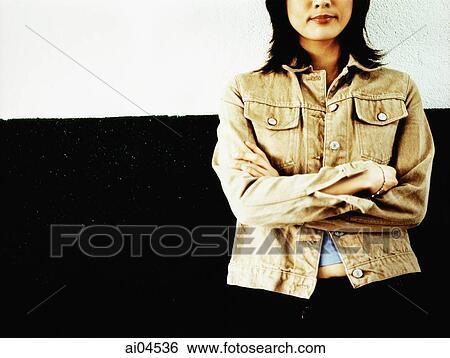 Lower torso of woman standing with arms crossed View Large Photo Image Stock Photograph - Lower torso of woman standing with arms crossed. Fotosearch