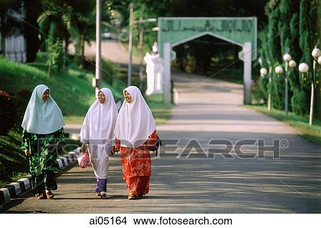 Malaysia, Johor Bahru, Muslim girls walking down a street. Picture