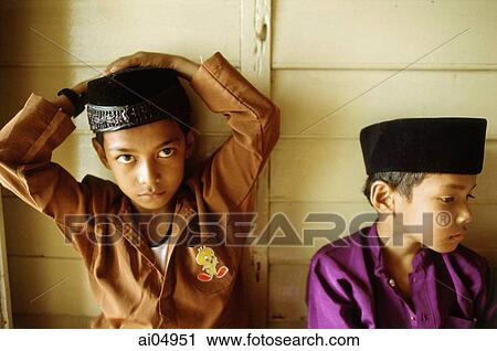 Malaysia, Kota Bharu, Young boys in traditional garb waiting for their Koran reading class to begin. View Large Photo Image Stock Image - Malaysia, Kota Bharu, Young boys in traditional garb waiting for their Koran reading class to begin.. Fotosearch
