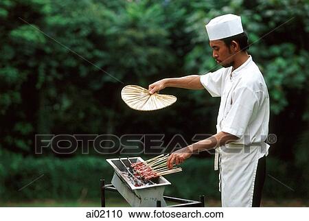Malaysia, Kuala Lumpur, a cook grilling satay over charcoal burner. View Large Photo Image Stock Image - Malaysia, Kuala Lumpur, a cook grilling satay over charcoal burner.. Fotosearch