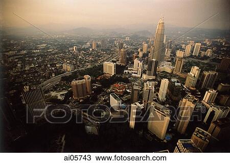 Stock Image - Malaysia, Kuala Lumpur, Aerial view of Petronas Towers and downtown Kuala Lumpur.. Fotosearch