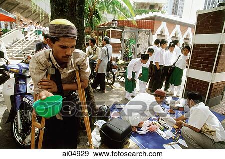 Malaysia, Kuala Lumpur, beggar on crutches waiting for donations outside the Friday Mosque. View Large Photo Image Stock Photo - Malaysia, Kuala Lumpur, beggar on crutches waiting for donations outside the Friday Mosque.. Fotosearch