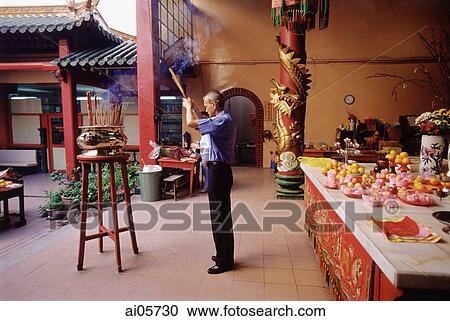 Malaysia, Kuala Lumpur, Chinatown, Man praying with joss sticks at Chinese temple. View Large Photo Image Stock Image - Malaysia, Kuala Lumpur, Chinatown, Man praying with joss sticks at Chinese temple.. Fotosearch
