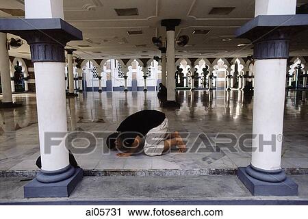 Malaysia, Kuala Lumpur, Muslim man praying at National Mosque (Masjid Negara). View Large Photo Image Stock Image - Malaysia, Kuala Lumpur, Muslim man praying at National Mosque (Masjid Negara).. Fotosearch