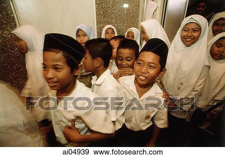Malaysia, Kuala Lumpur, Muslim students filing out of classroom for their mid-morning snack at the National Mosque. View Large Photo Image Stock Photo - Malaysia, Kuala Lumpur, Muslim students filing out of classroom for their mid-morning snack at the National Mosque.. Fotosearch