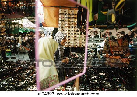 Malaysia, Kuala Lumpur, Muslim women signified by the use of a tudong, or head scarf. View Large Photo Image Stock Photo - Malaysia, Kuala Lumpur, Muslim women signified by the use of a tudong, or head scarf.. Fotosearch