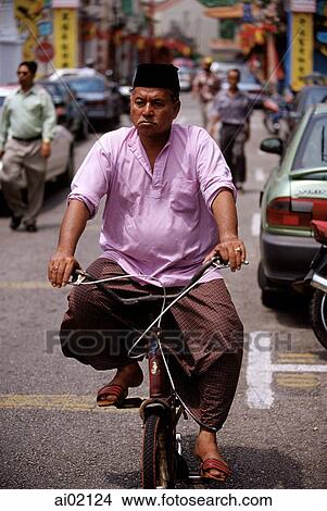 Malaysia, Malacca, Muslim man on bicycle. View Large Photo Image Picture - Malaysia, Malacca, Muslim man on bicycle.. Fotosearch
