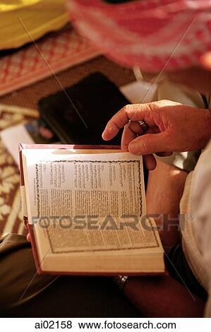 Stock Photo - Malaysia, Muslim man reads from Koran.. Fotosearch