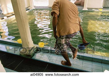 Malaysia, Penang, Indian Muslim washing his feet in a ritual of ablution before prayers at the Kapitan Kling Mosque. View Large Photo Image Stock Photography - Malaysia, Penang, Indian Muslim washing his feet in a ritual of ablution before prayers at the Kapitan Kling Mosque.. Fotosearch