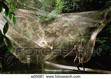 Stock Image - Malaysia, Sarawak, Iban fisherman casting net. Fotosearch