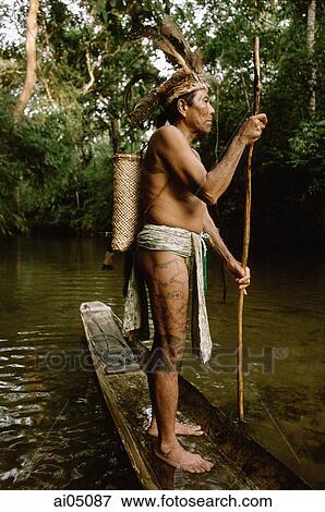 Malaysia, Sarawak, Iban man in small boat View Large Photo Image Stock Photo - Malaysia, Sarawak, Iban man in small boat. Fotosearch