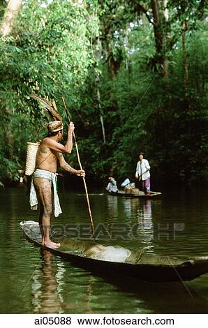 Malaysia, Sarawak, Iban man in small boat View Large Photo Image Stock Photo - Malaysia, Sarawak, Iban man in small boat. Fotosearch