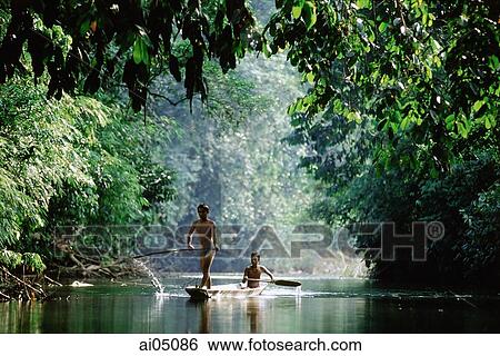 Malaysia, Sarawak, Iban men on boat View Large Photo Image Stock Photograph - Malaysia, Sarawak, Iban men on boat. Fotosearch