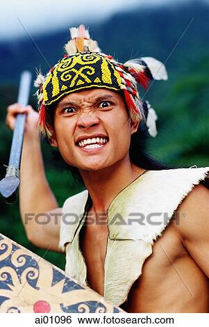 Stock Photograph - Malaysia, Sarawak, Santubong Cultural Village, Orang Ulu Warrior in traditional dress. Fotosearch
