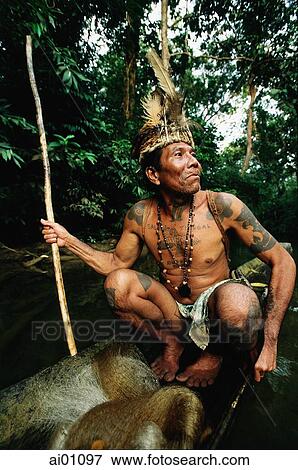 Malaysia, Sarawak, Sri Aman Division, Iban man sitting in small boat View Large Photo Image Stock Photo - Malaysia, Sarawak, Sri Aman Division, Iban man sitting in small boat. Fotosearch