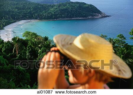 Stock Photo - Malaysia, Terengganu State, Pulau Perhintian, Long Beach, tourist holding binoculars. Fotosearch