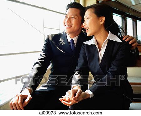 Male and female executive looking out window View Large Photo Image Stock Image - Male and female executive looking out window. Fotosearch